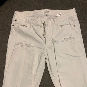 All White jeans with tattered ankles